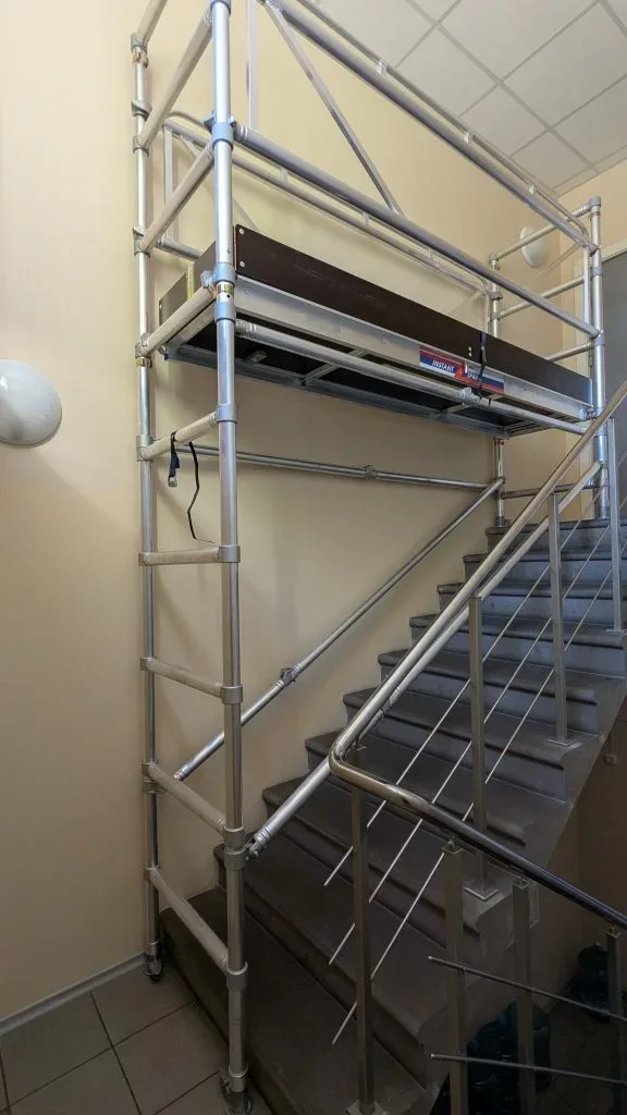 Upright scaffold installed in a commercial stairwell